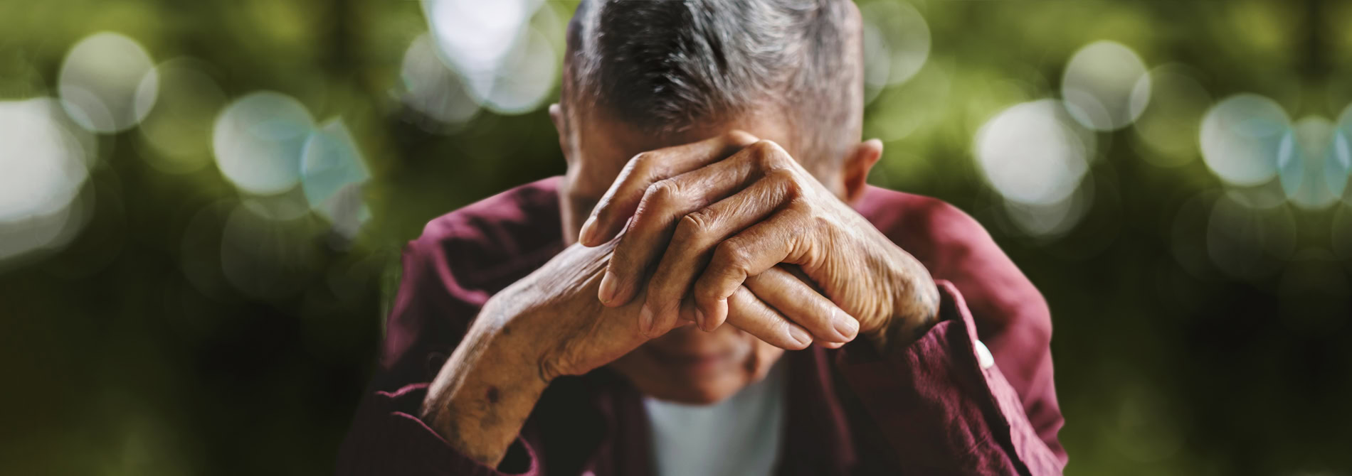 Senior man with hands folded